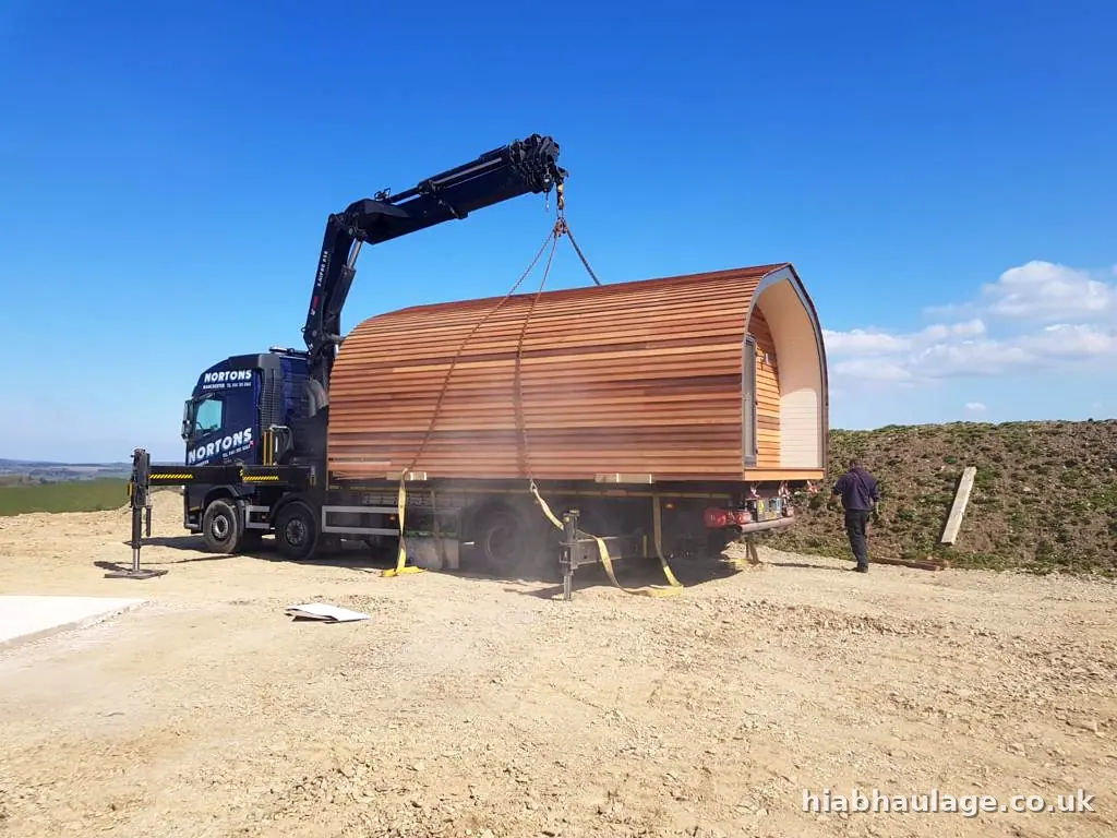 Timber glamping pod being lifted from a flatbed by a Volvo HIAB Timber glamping pod being lifted from a flatbed by a Volvo HIAB